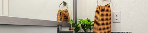 a kitchen counter with a sink and a mirror