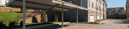 an empty parking lot with an apartment building in the background
