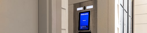 an atm on the side of a building with a blue screen