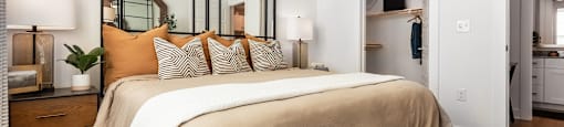 a bedroom with a large bed and a mirror