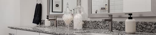 an example of a bathroom with a granite counter top and a sink and a mirror