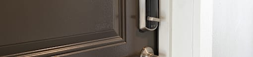 a door with a silver door handle and a white door frame