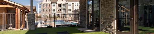 the yard of a home with yoga mats and a pool