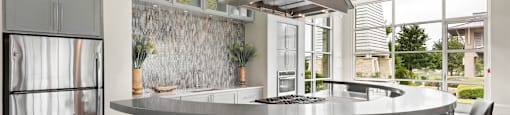 a kitchen with a large island with a breakfast bar