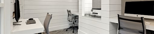 a workspace with two desks and two chairs