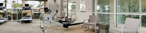 a resident fitness center with a treadmill and elliptical machine