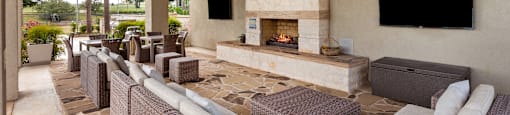 a patio with couches and a fireplace