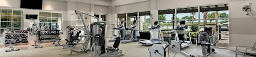 a spacious fitness center with treadmills and other exercise equipment