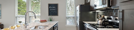 a kitchen with dark cabinets and white countertops