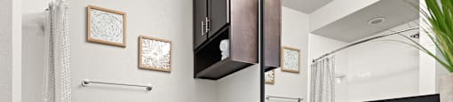 a bathroom with dark cabinets and a white toilet