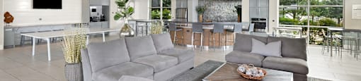 a living room filled with furniture and a large window