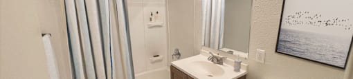 a bathroom with a toilet sink and shower in a 555 waverly unit