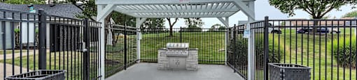 a patio with a pavilion and a fire pit