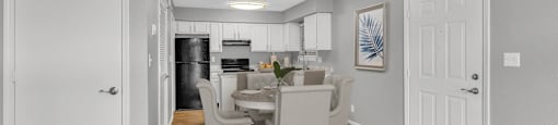 a dining room and kitchen with white chairs and a table