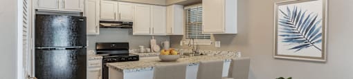 a kitchen and dining room with white cabinets and a table and chairs