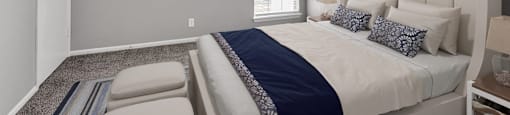 a bedroom with a large bed and a window