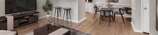 an open living room and dining room area with a tv and a table and chairs