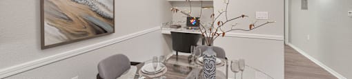 a dining room with a glass table and chairs