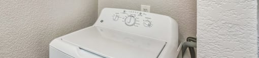 the laundry room has a washer and dryer and a shower