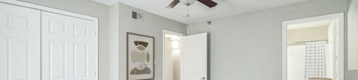a bedroom with a large bed and a ceiling fan