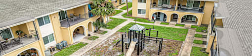 an aerial view of a playground in the yard of an apartment building