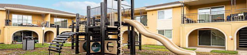 a playground with a slide    and apartments