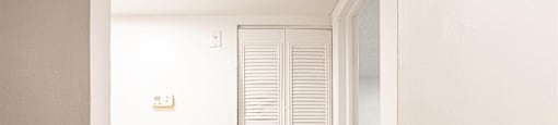 a room with a white door and a closet