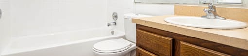 a bathroom with a sink toilet and a bath tub