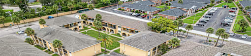 an aerial view of a swimming pool in front of some houses