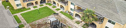an aerial view of the courtyard of an apartment building with a playground