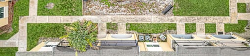 a birds eye view of a yard with a pool and lounge chairs