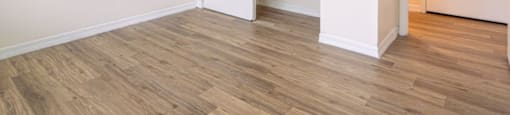 an empty room with a closet and a hard wood floor