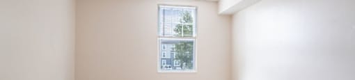 a room with pink and white walls and a window