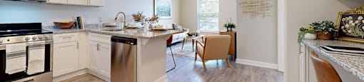 A kitchen with a stove, oven, and a dining table with chairs.