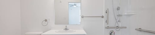 A white bathroom with a toilet, sink, and bathtub.