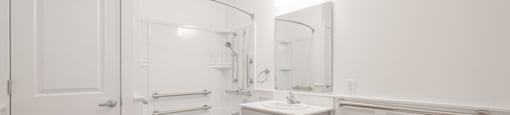 A white bathroom with a toilet, sink, and bathtub.
