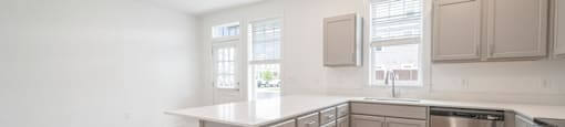 A kitchen with wooden floors and stainless steel appliances.