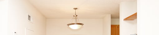 A room with wooden floors and a ceiling light.