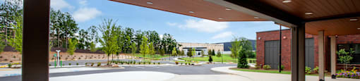 a view of the pool area from under a wood canopy