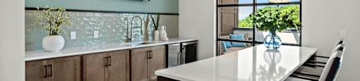 a kitchen with a large island and a table with chairs