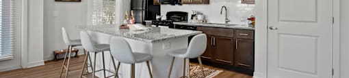 A modern kitchen with a dining table and chairs.