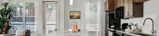 A modern kitchen with a dining table and chairs.