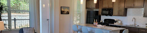 A modern kitchen with a dining table and chairs.