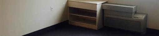 A room with a window and a filing cabinet.