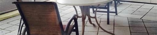 A patio with a table and chairs under a canopy.