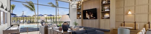 the living room has a large window overlooking the pool and the beachat Westbury Apartments, Rancho Cucamonga, California