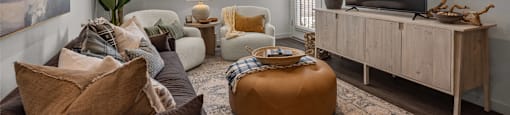a living room with couches and a tvat Westbury Apartments, California