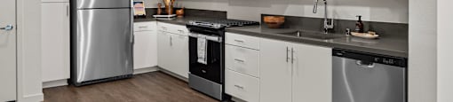 a kitchen with white cabinets and stainless steel appliancesat Westbury Apartments, Rancho Cucamonga, 91739