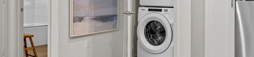 a white washer and dryer in a closet with a doorat Westbury Apartments, Rancho Cucamonga, CA