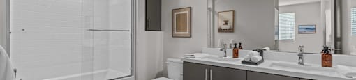 a bathroom with a shower toilet and sink and a mirrorat Westbury Apartments, Rancho Cucamonga, California